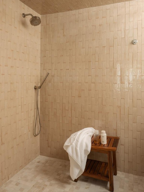 Monte Vista — walk-in shower in soft-toned handmade-look tile with a wood bench