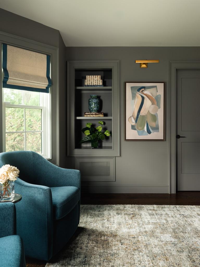 Monte Vista — sitting area with teal swivel chairs, a built-in display niche and framed artwork