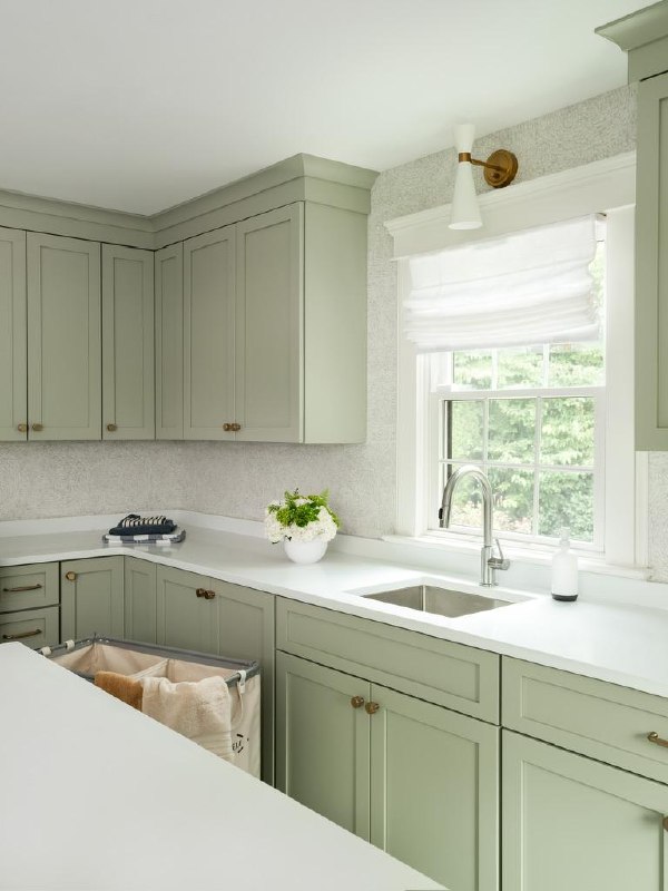 Monte Vista — laundry room sink corner with sage cabinetry and pull-out hampers
