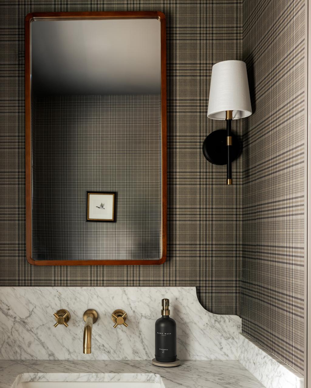 Monte Vista — powder room with plaid wallcovering, a stone vanity and brass fittings