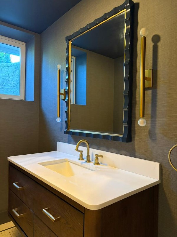 Monte Vista — powder room with a scalloped dark mirror, brass sconces and a wood vanity